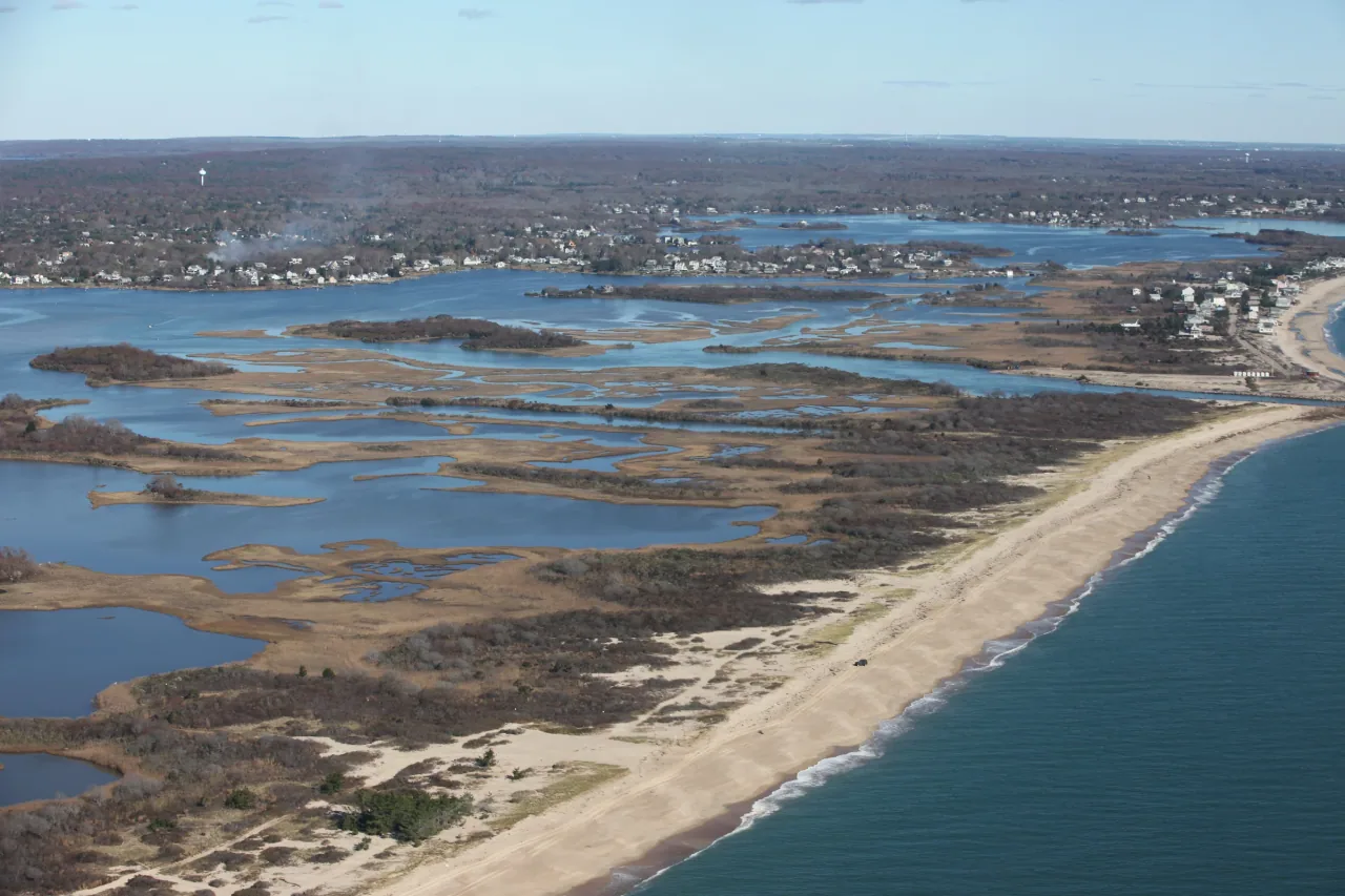 Aerial view of the beach, salt pond, and wetlands around Ninigret National Wildlife Refuge.