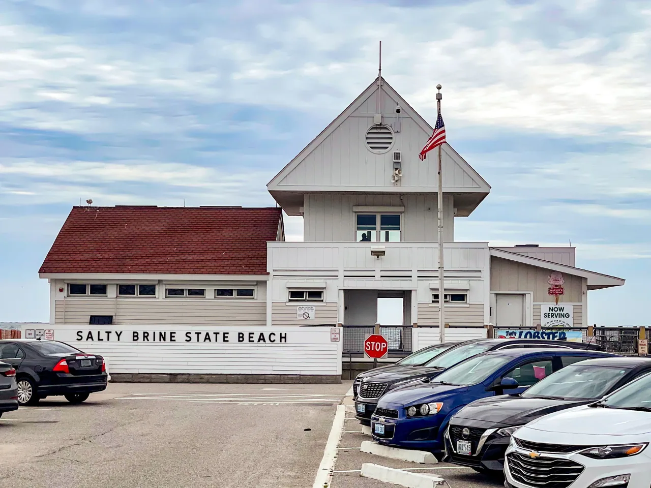 The white pavilion and entrance sign at Salty Brine State Beach.