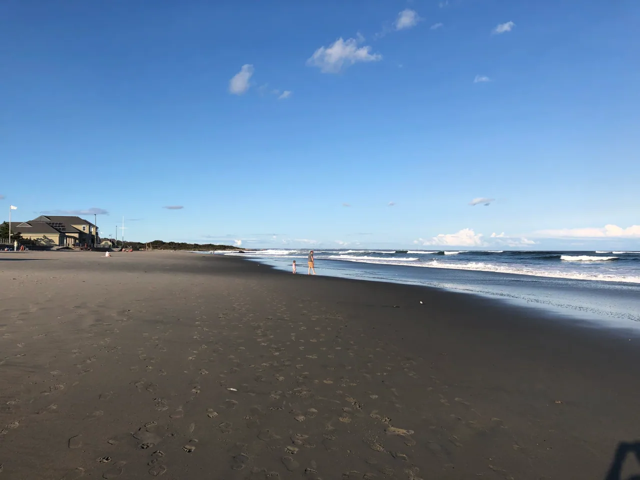 Waves roll onto Scarborough North State Beach beside its pavilion.